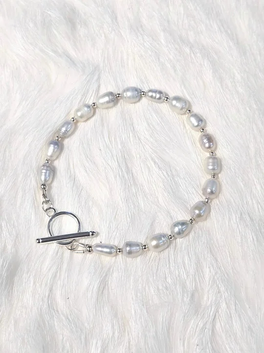 Bracelet of lavender rice-shaped freshwater pearls with tiny silver beads and a silver toggle clasp