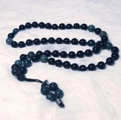 Hand-knotted mala necklace of black onyx and green moss agate beads with a moss agate tassel and silver accents