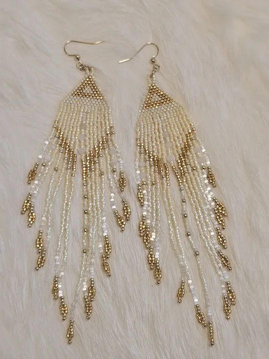 Long beaded fringe earrings in ivory, champagne and metallic gold, on white fur