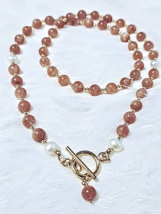 Peach sunstone and freshwater pearl necklace with a gold toggle and a sunstone drop