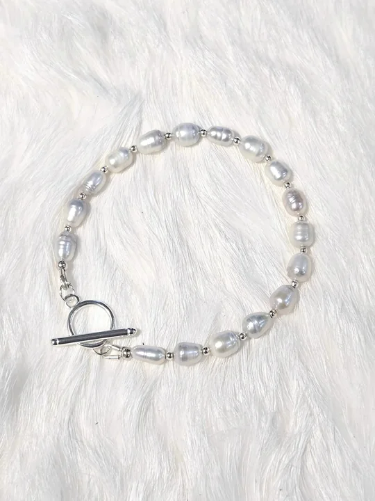 Rice-shaped white freshwater pearl bracelet with tiny sterling silver beads and a silver toggle clasp